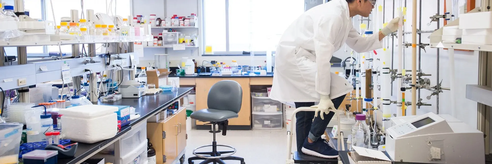 Person in a lab environment wearing safety gear