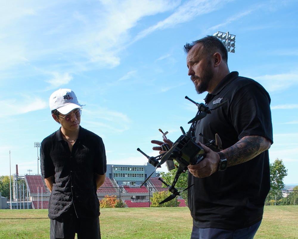 Student works with the drone pilot