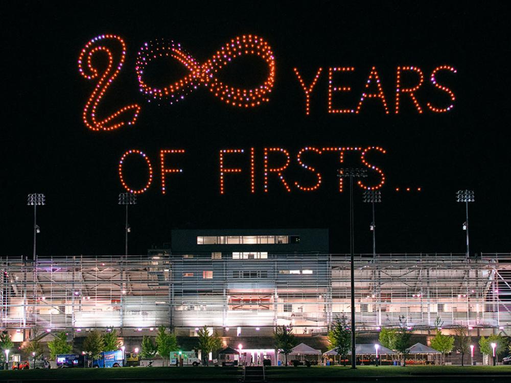 '200 Years of Firsts' displayed above a sports stadium at night.